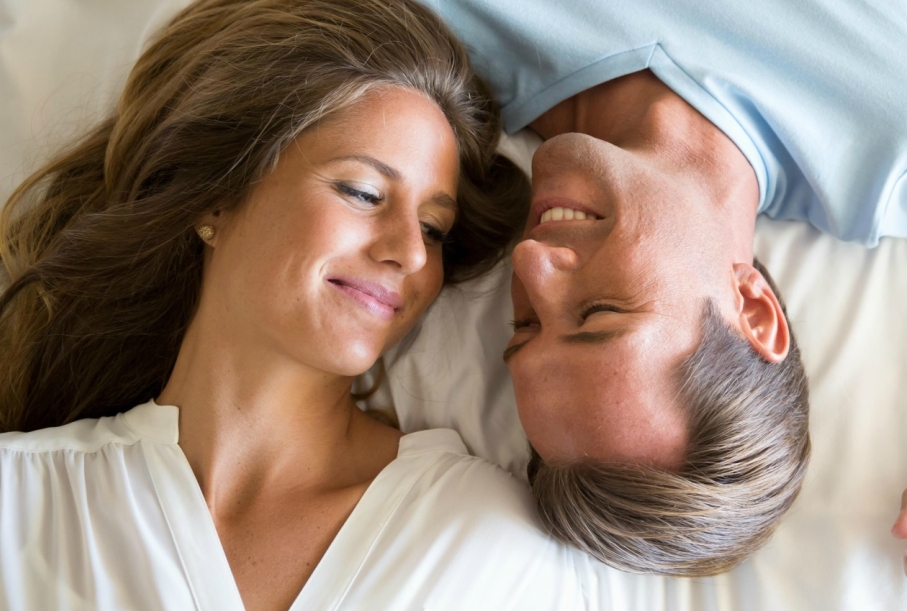 man and woman lying in bed