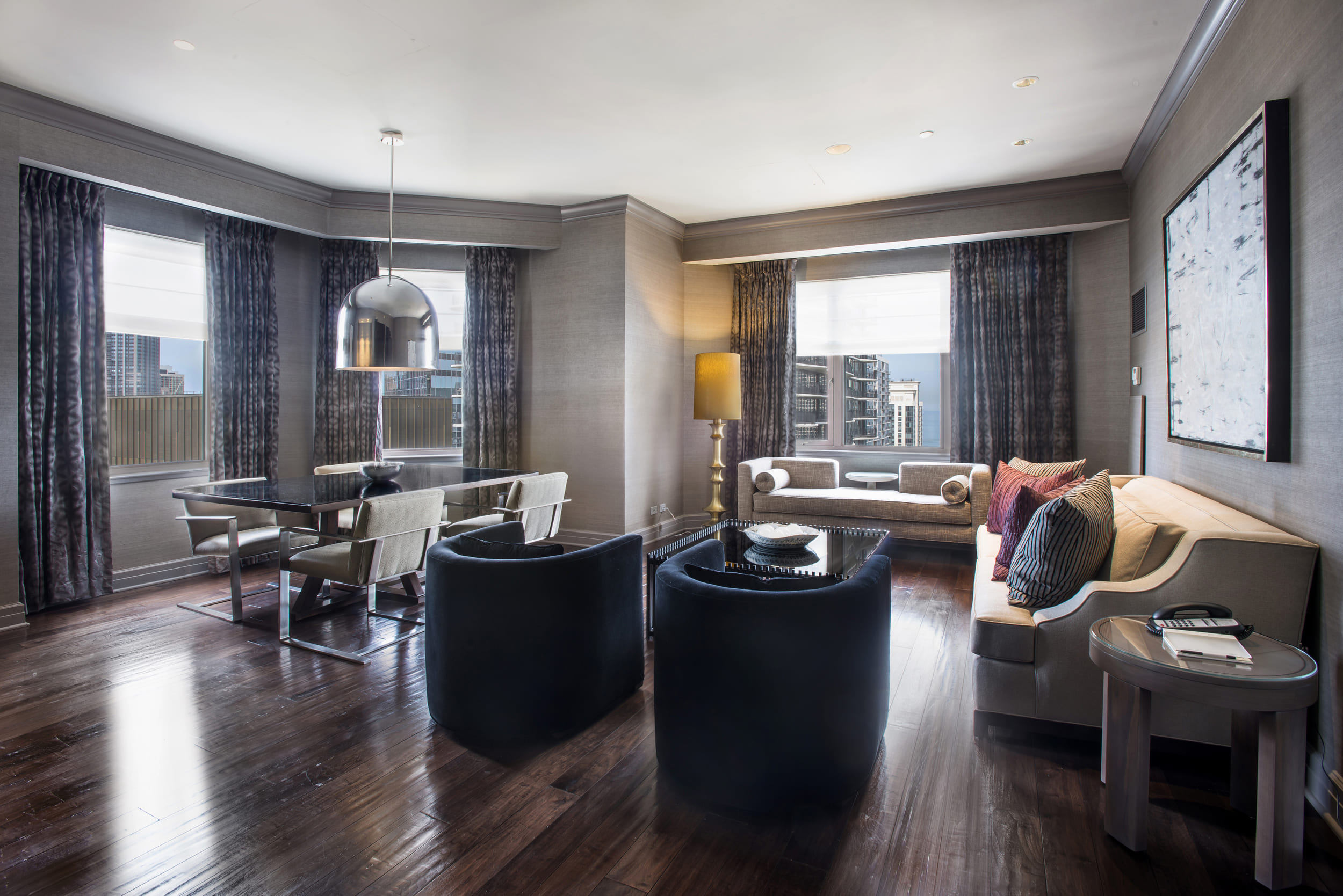 living room area with sectional and two chairs