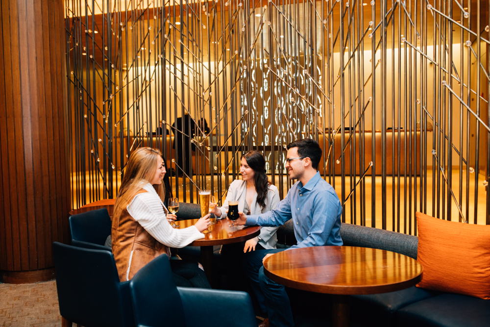 a group of people drinking in lobby bar