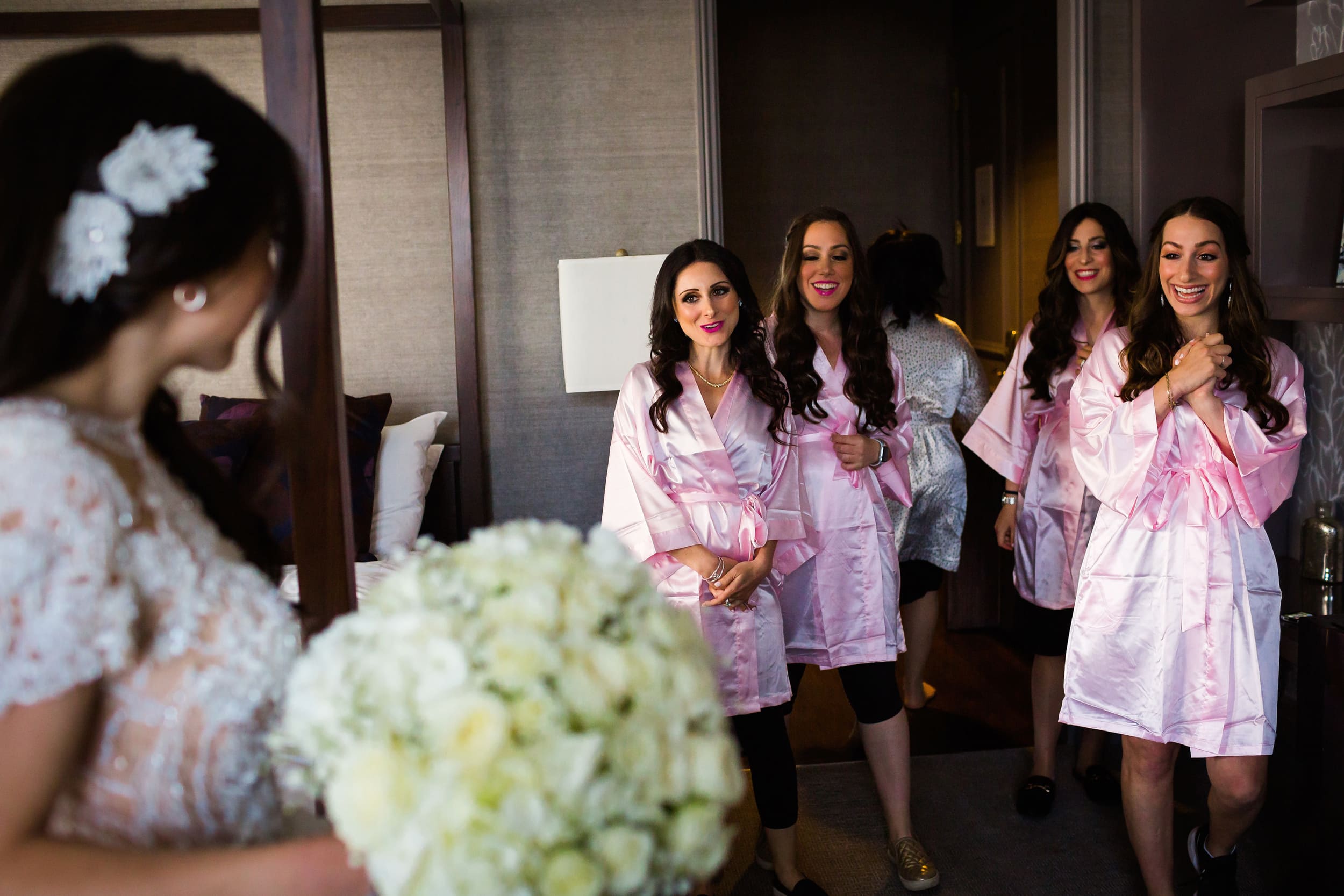 bridesmaids seeing bride in dress for the first time