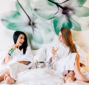 woman drinking wine in bed