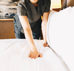 hotel worker making bed