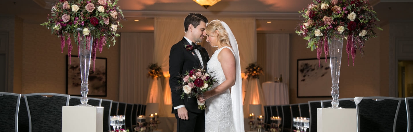bride and groom posing in aisle
