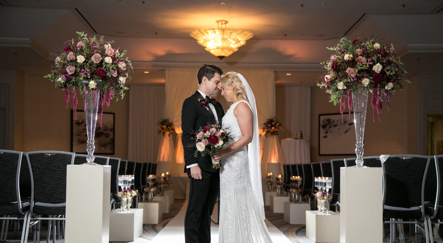 bride and groom posing in aisle
