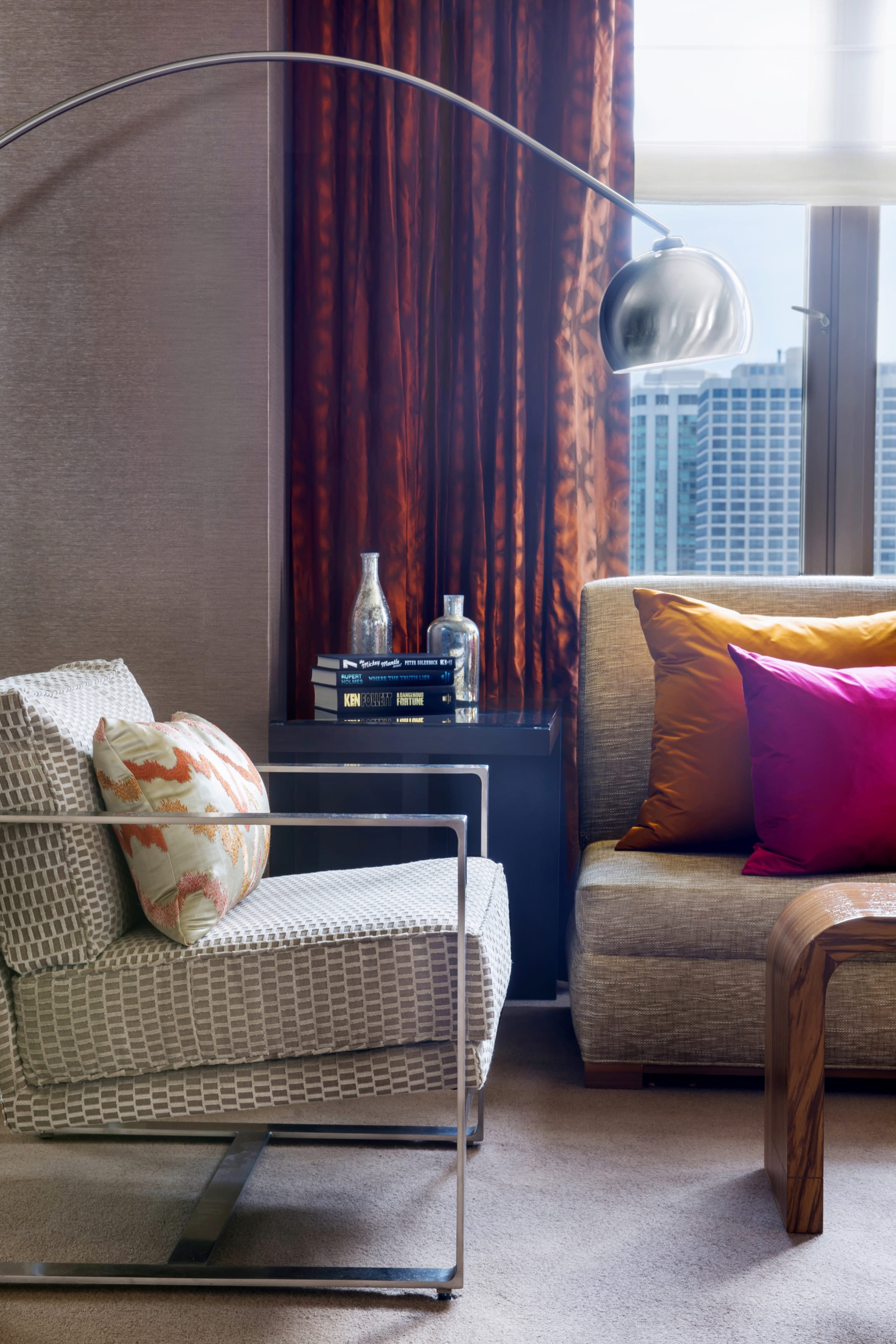living room with arching lamp over a reading chair