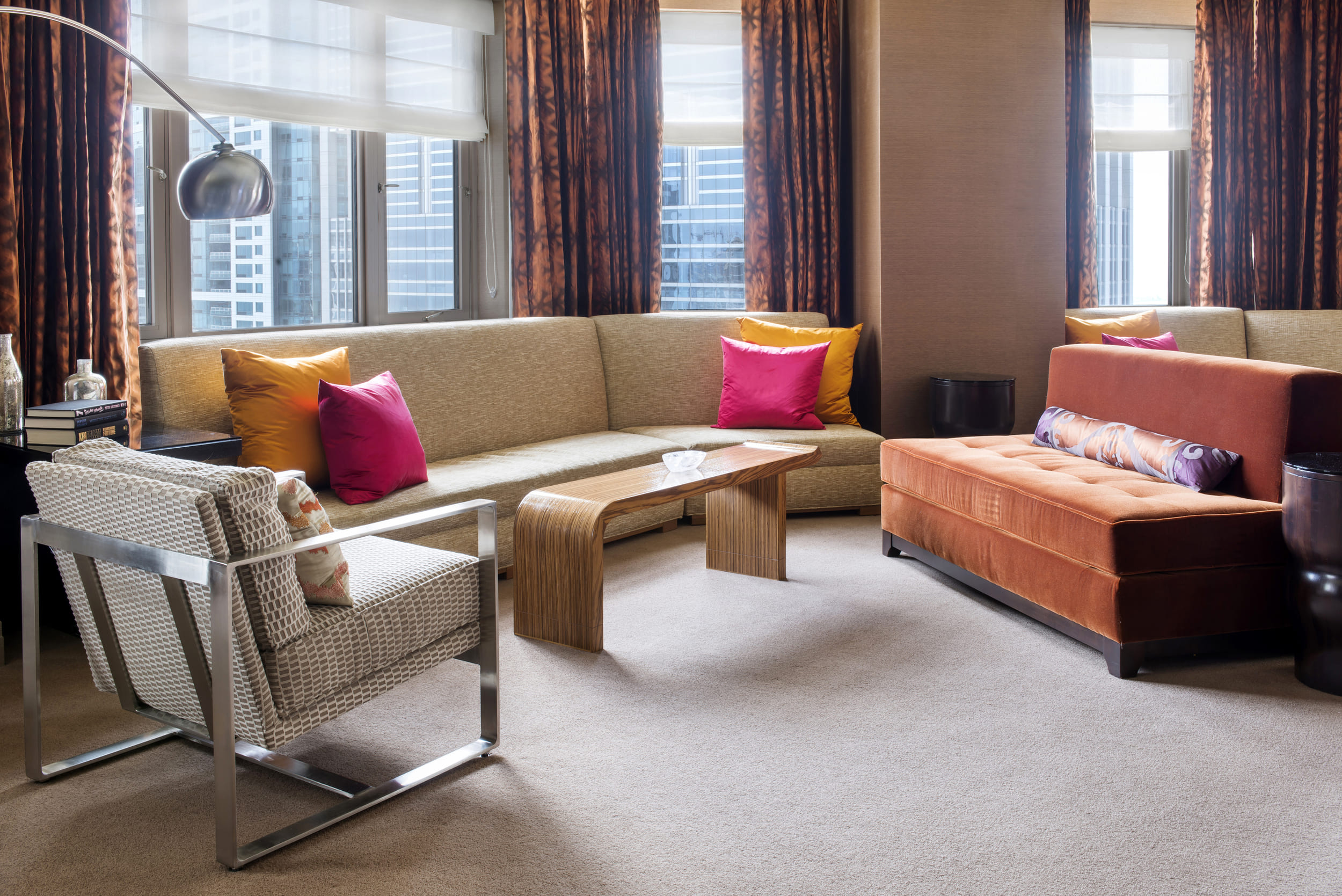 living room with arching lamp over a reading chair